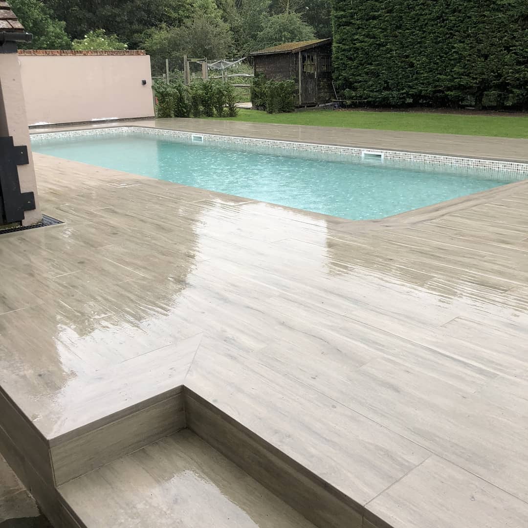 Completed hip-to-gable loft conversion on a 1930s Chingford semi-detached home with rear dormer — Reinforced concrete swimming pool with porcelain timber-look deck and overflow detail — swimming pool construction by RJS Innovative Building, East London
