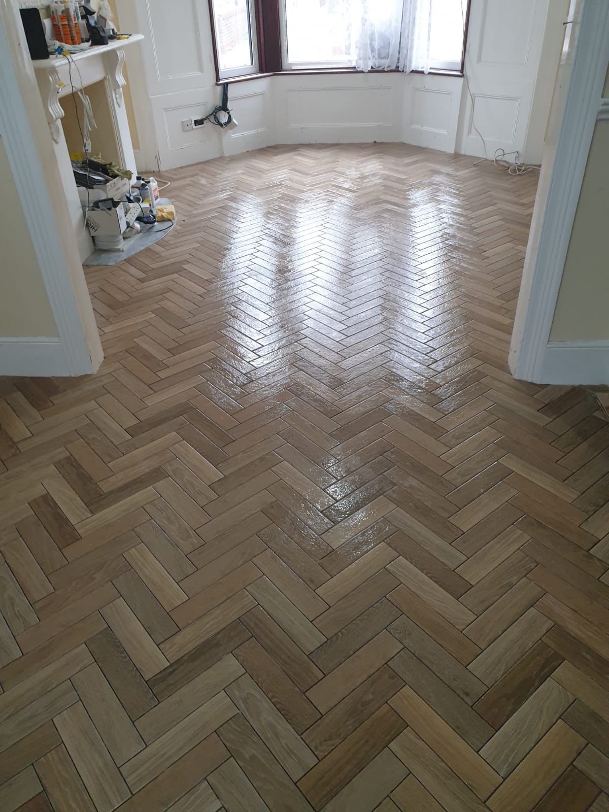 Tiling — Bathrooms & Kitchens in Buckhurst Hill, IG9 — Wood-effect porcelain herringbone parquet floor tiling laid through a Victorian reception room — tiling by RJS Innovative Building, East London